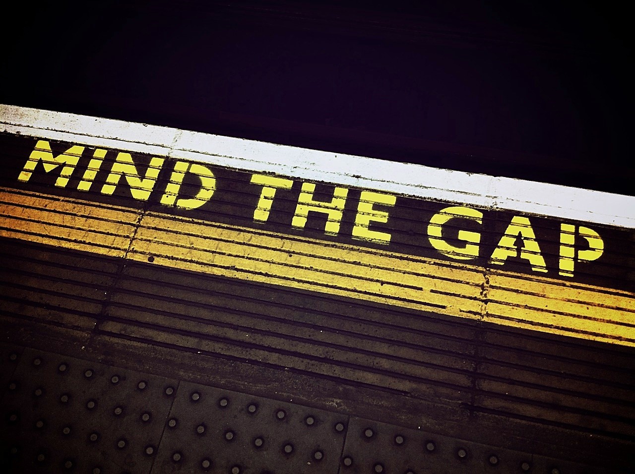 Mind the Gap sign from a subway platform